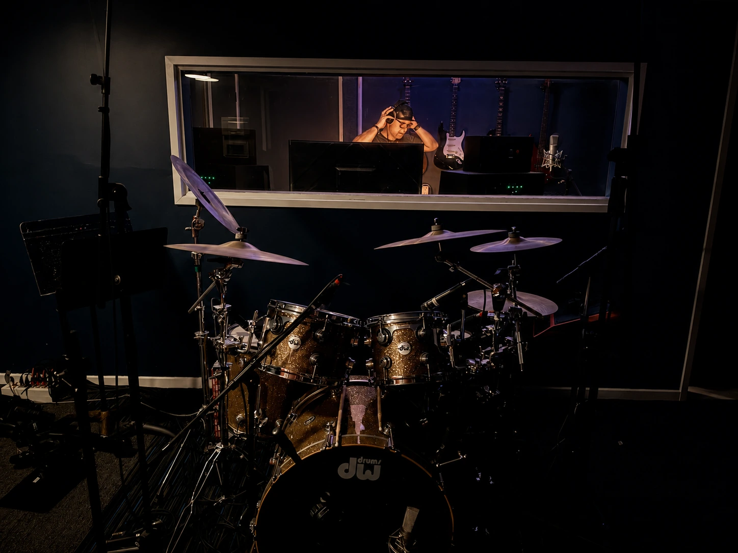 Steve Rault in the control room, seen through the studio window
